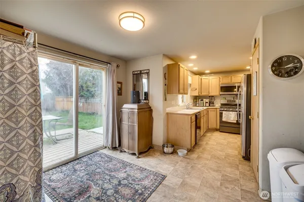 a view of kitchen with furniture and refrigerator