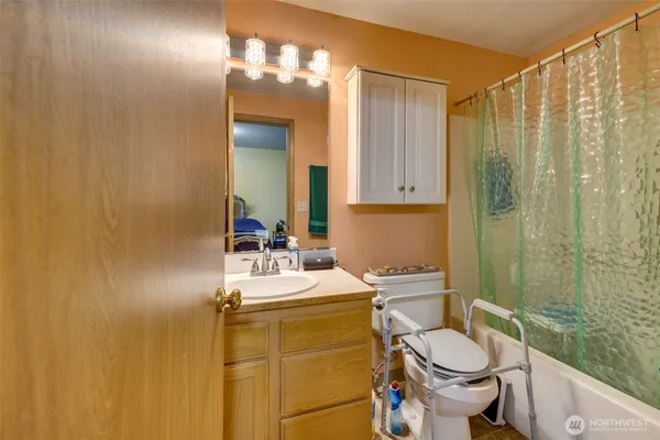 a bathroom with a sink vanity mirror and toilet