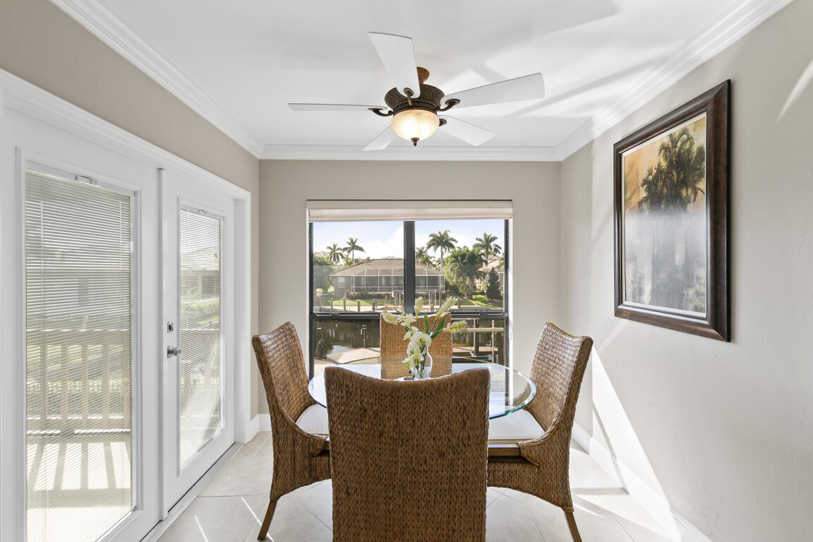 110 June Court Marco Island, FL 34145 - Photo 11 of 41 a dining room with furniture a chandelier and wooden floor