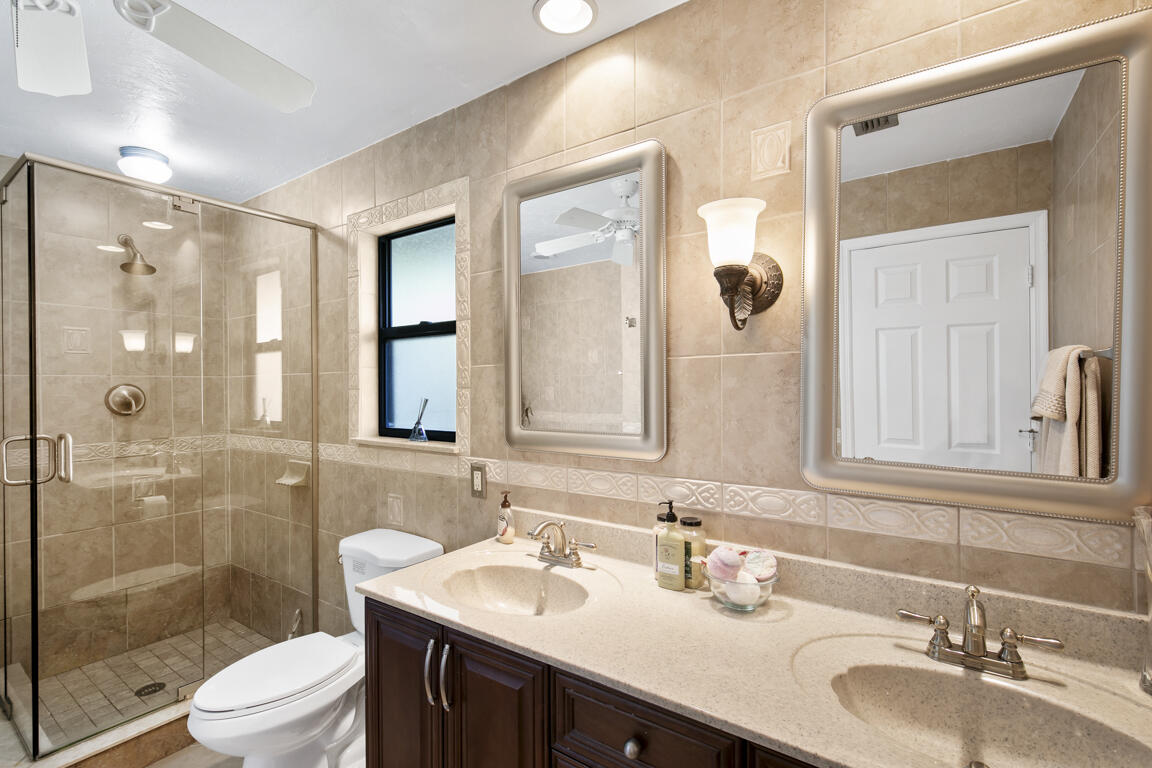 110 June Court Marco Island, FL 34145 - Photo 14 of 41 a bathroom with a sink a toilet and shower