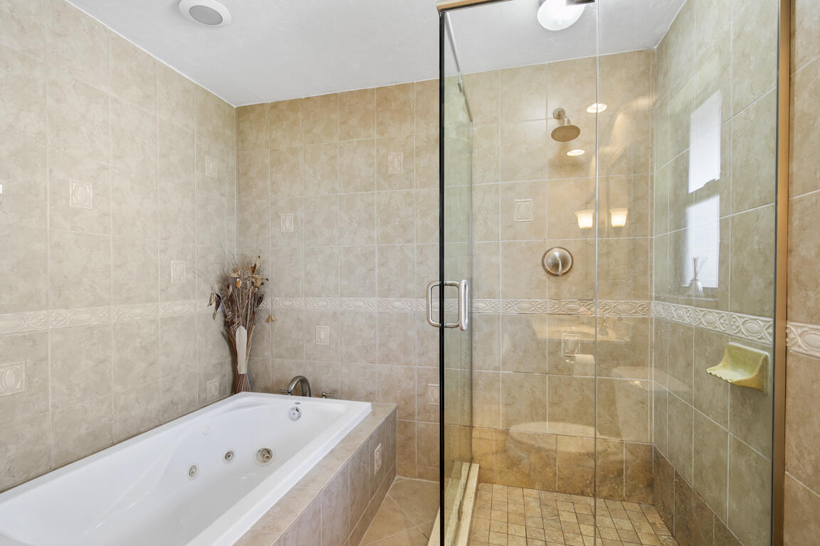 110 June Court Marco Island, FL 34145 - Photo 15 of 41 a bathroom with a bathtub and a shower