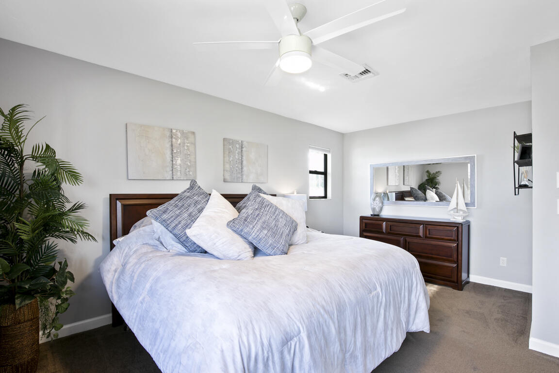 110 June Court Marco Island, FL 34145 - Photo 18 of 41 a bedroom with a large bed and a chandelier