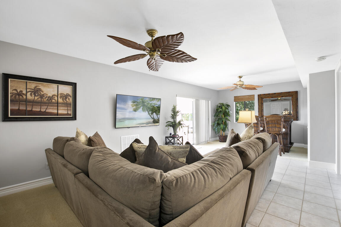 110 June Court Marco Island, FL 34145 - Photo 19 of 41 a living room with furniture a ceiling fan and a window