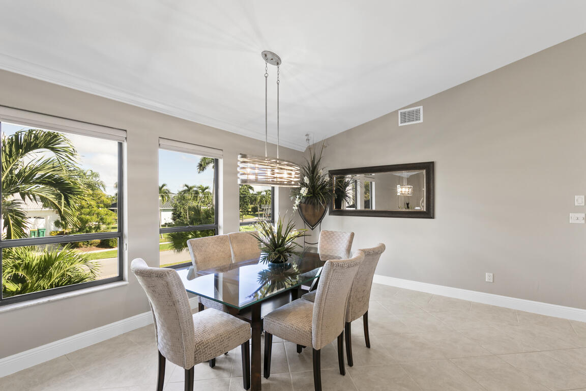 110 June Court Marco Island, FL 34145 - Photo 3 of 41 a dining room with furniture a chandelier and wooden floor