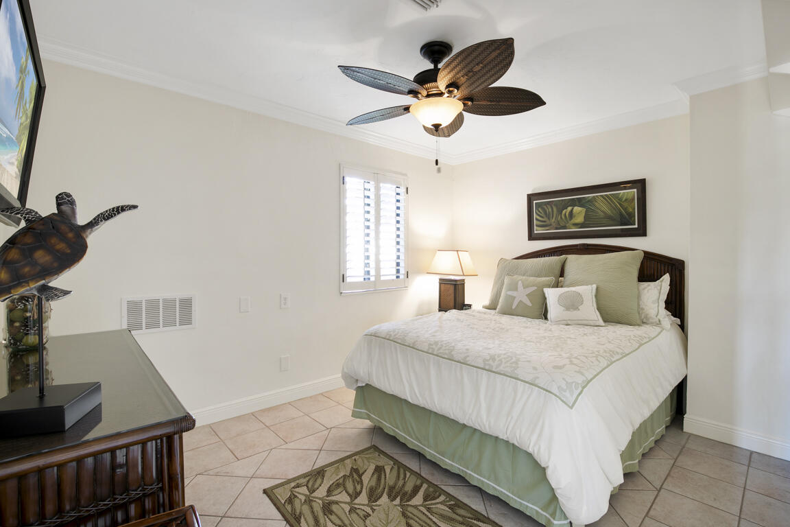 110 June Court Marco Island, FL 34145 - Photo 22 of 41 a bedroom with a bed and a chandelier