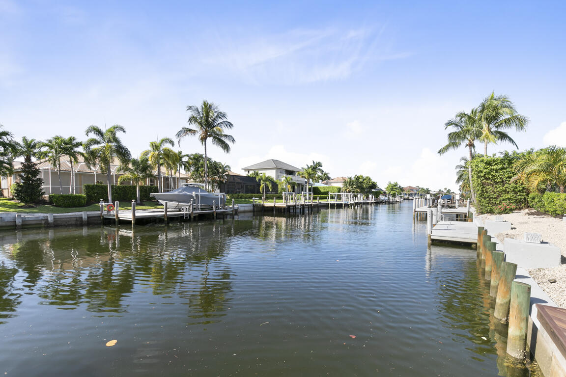 110 June Court Marco Island, FL 34145 - Photo 26 of 41 a view of a lake with boats and trees in the background