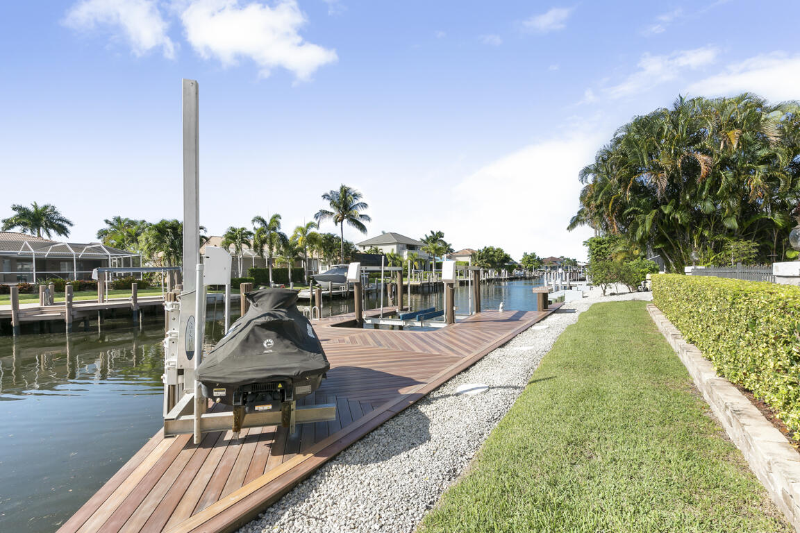 110 June Court Marco Island, FL 34145 - Photo 27 of 41 a view of a lake with couches in the patio