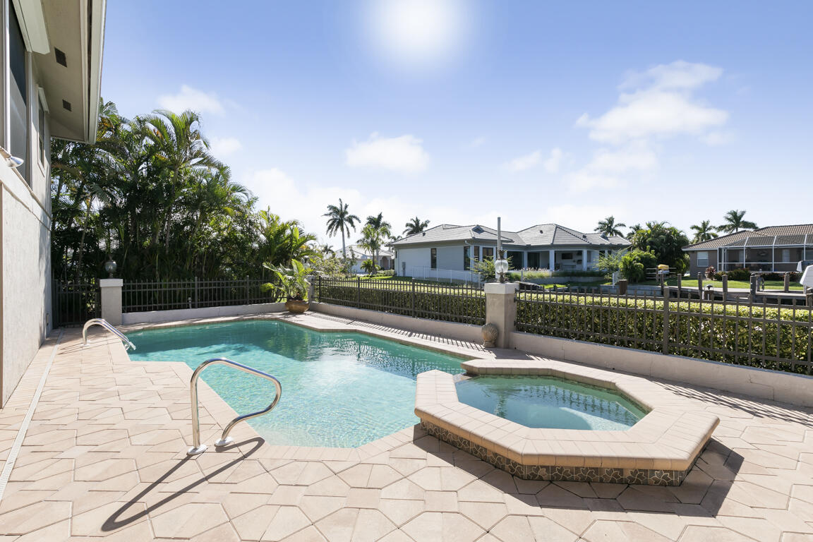 110 June Court Marco Island, FL 34145 - Photo 32 of 41 a view of a swimming pool with a lounge chair