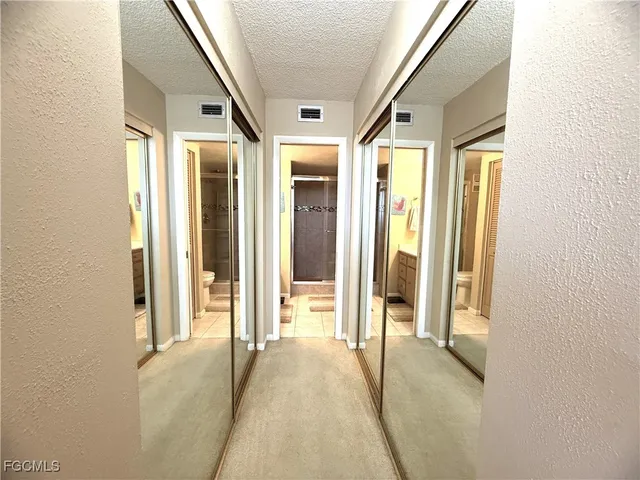 a bedroom with a bed and a couch next to a window