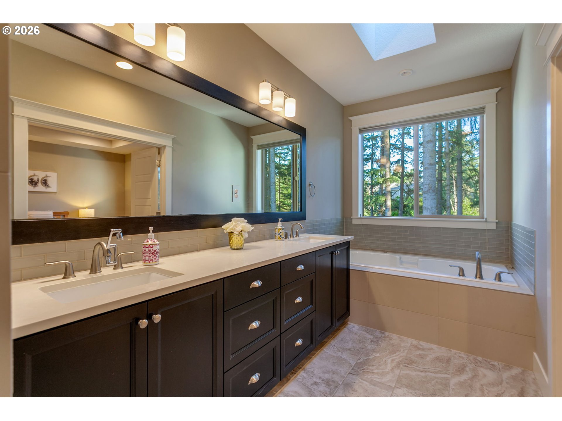 14390 Southwest Fox Lane Beaverton, OR 97008 - Photo 31 of 47 a bathroom with a tub double vanity sink and mirror