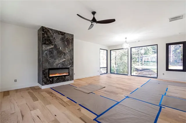 a view of an empty room with a fireplace and a window