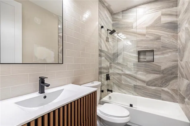 a bathroom with a sink toilet and shower