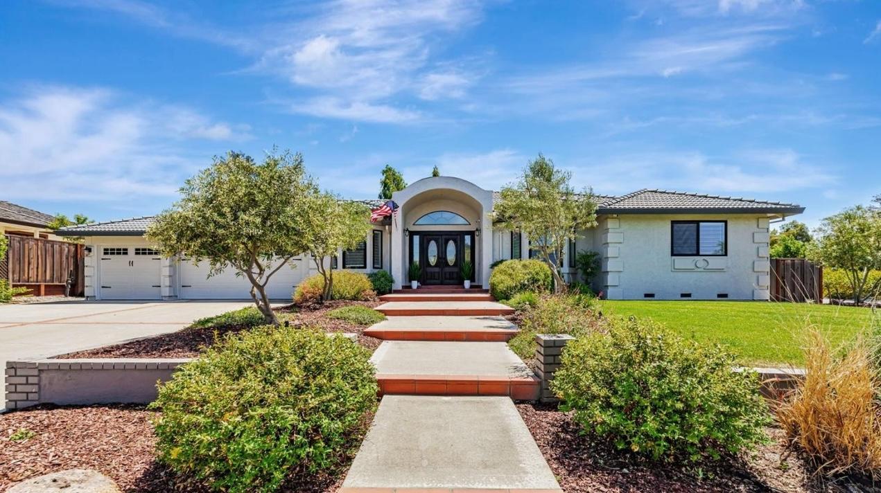 a front view of a house with garden