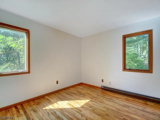 a view of a room with wooden floor and window