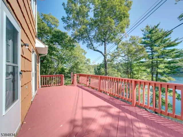 a view of balcony with wooden floor and fence