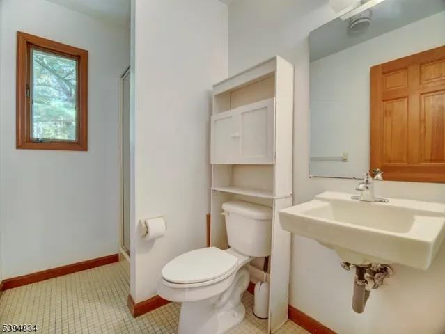a bathroom with a sink toilet and mirror
