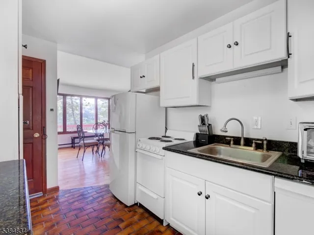 a kitchen with sink cabinets and dining table