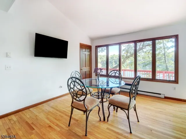 a dining room with furniture and wooden floor