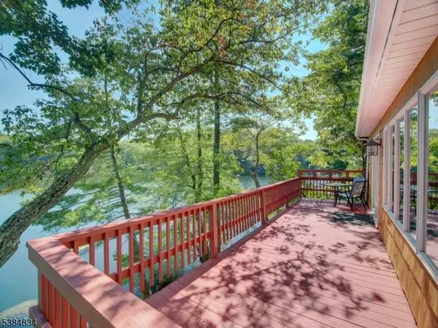 a view of balcony with wooden floor and fence
