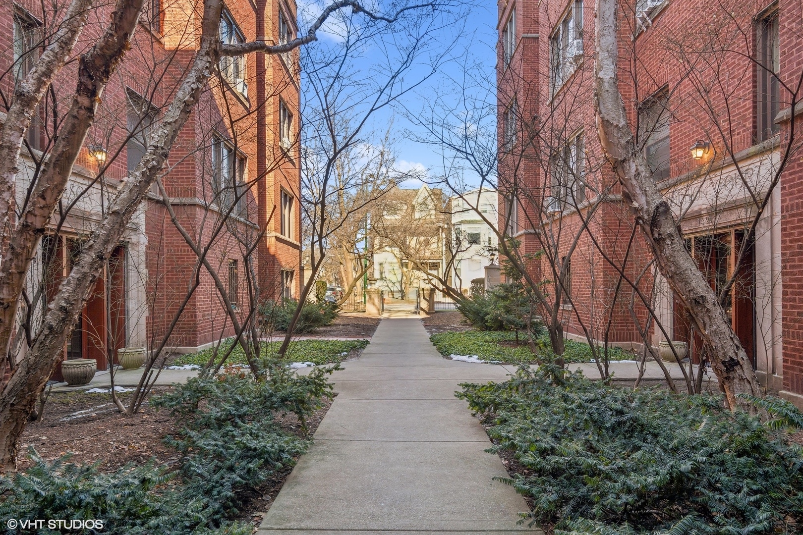 1323 West Addison Street, Unit 1A Chicago, IL 60613 - Photo 1 of 15 a view of a pathway with house on both side