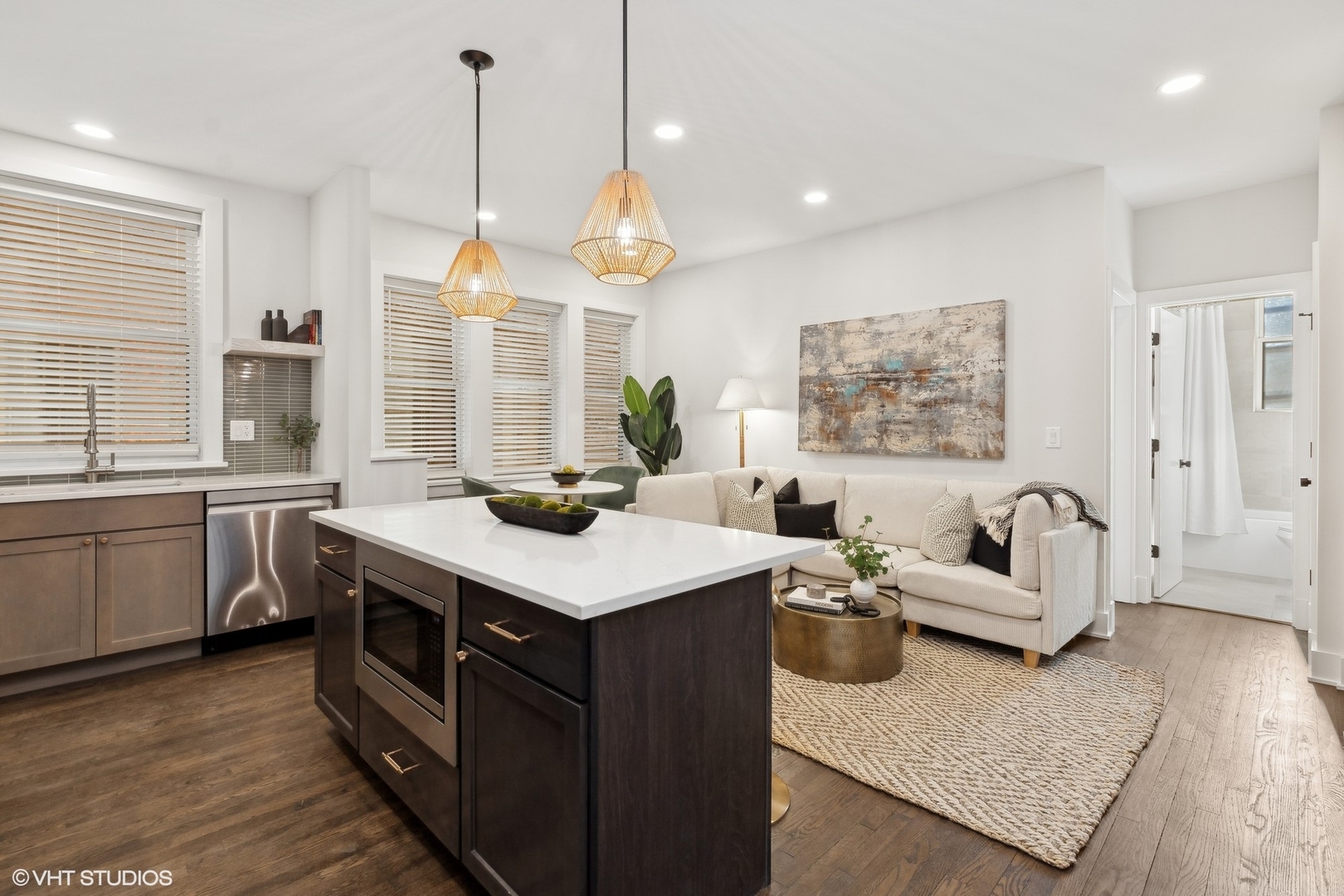 1323 West Addison Street, Unit 1A Chicago, IL 60613 - Photo 7 of 15 a kitchen with a stove a sink and a living room view