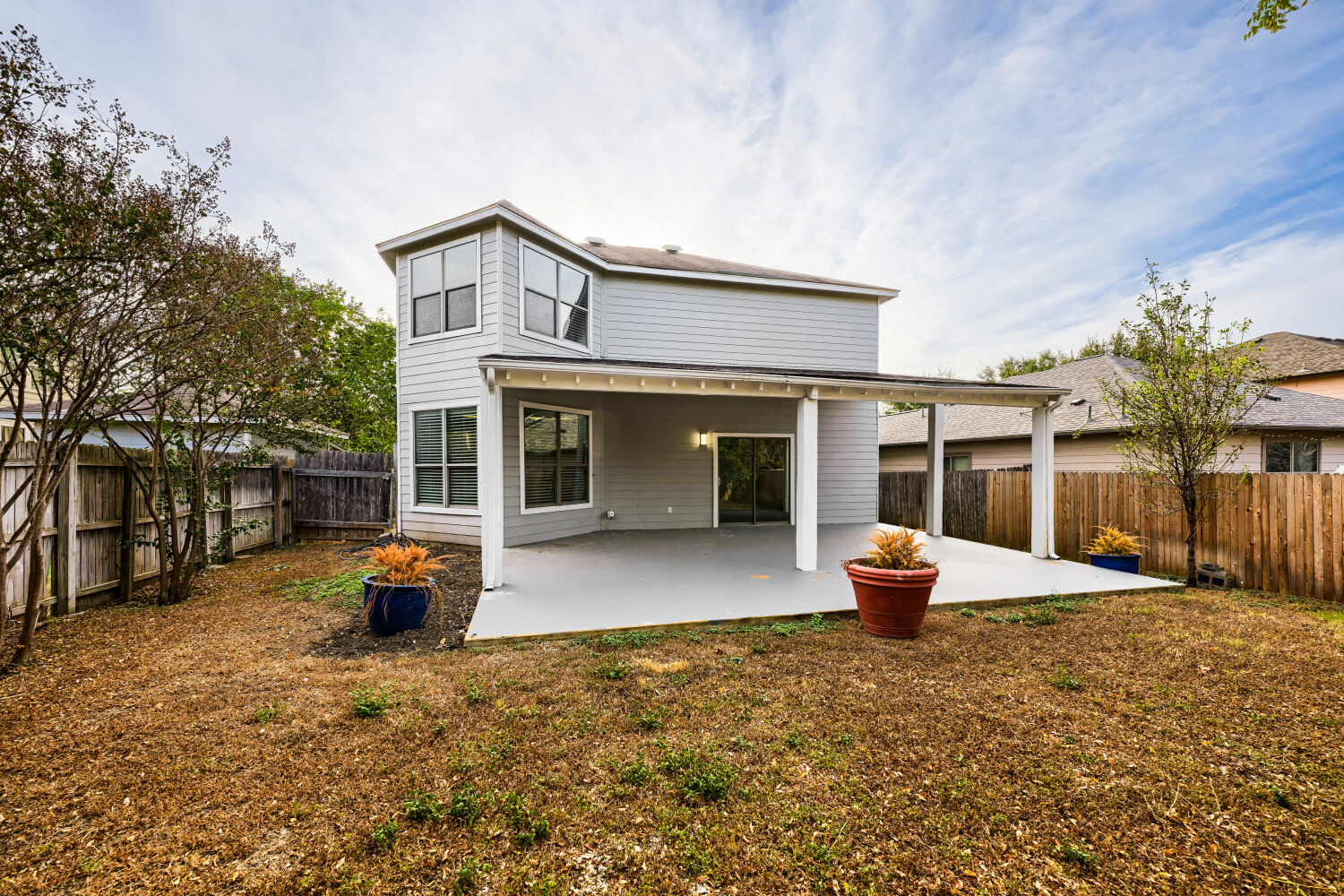 4508 Peach Grove Road Austin, TX 78744 - Photo 2 of 22 A spacious covered patio overlooks the fenced backyard of this two-story home.
