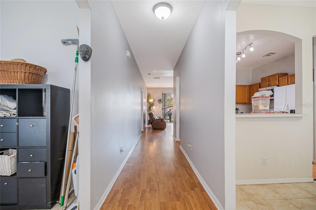 2782 Andes Way St. Cloud, FL 34769 - Photo 20 of 42 a view of a hallway with wooden floor and a bathroom