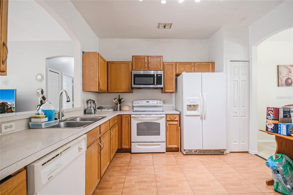 2782 Andes Way St. Cloud, FL 34769 - Photo 22 of 42 a kitchen with stainless steel appliances granite countertop a refrigerator sink and stove