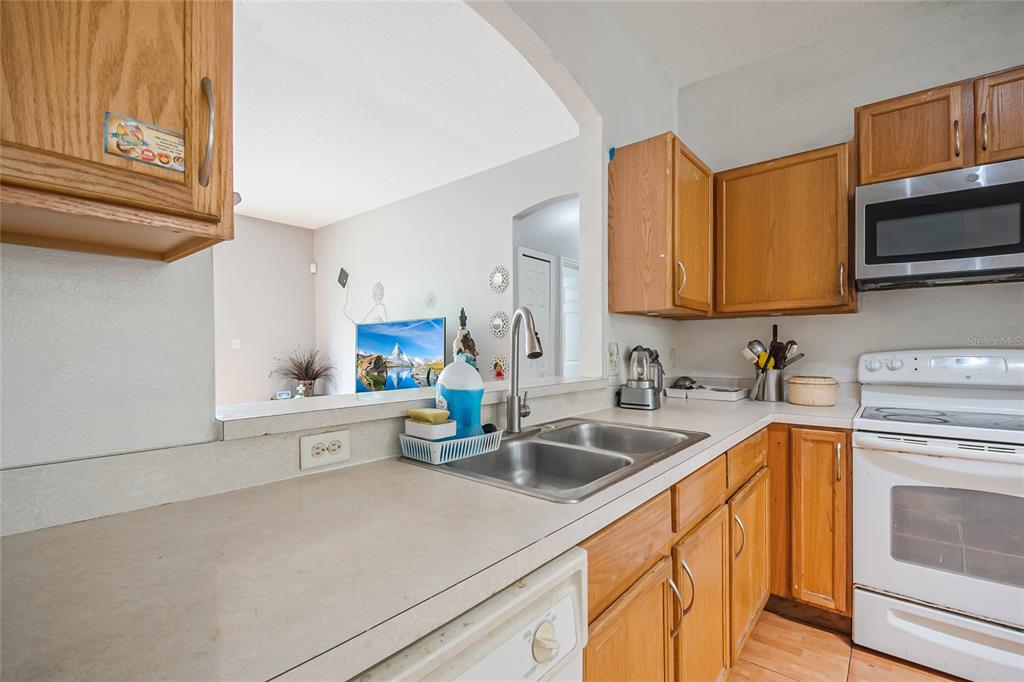 2782 Andes Way St. Cloud, FL 34769 - Photo 24 of 42 a kitchen with stainless steel appliances granite countertop a sink and a stove