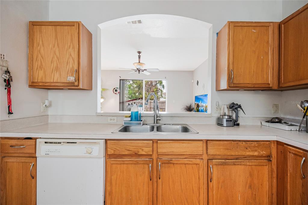 2782 Andes Way St. Cloud, FL 34769 - Photo 27 of 42 a kitchen with stainless steel appliances granite countertop a sink a stove and cabinets