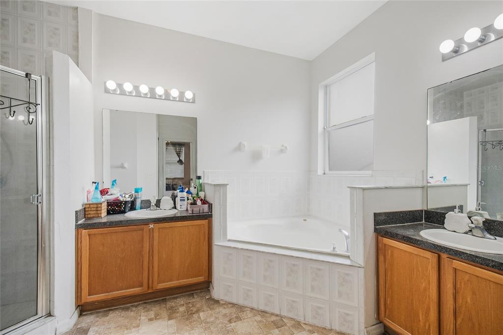 2782 Andes Way St. Cloud, FL 34769 - Photo 31 of 42 a bathroom with a sink vanity tub and shower