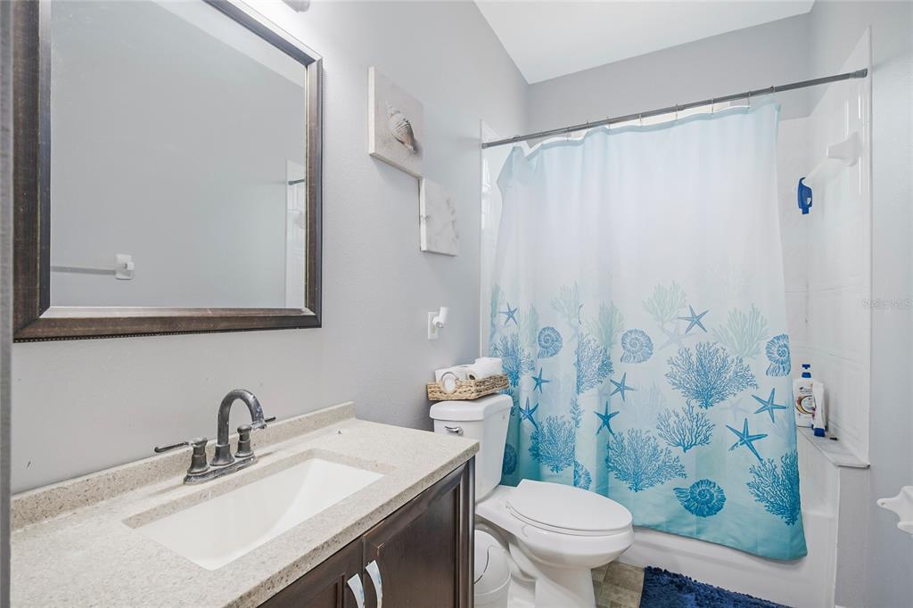 2782 Andes Way St. Cloud, FL 34769 - Photo 38 of 42 a bathroom with a sink a toilet and shower curtain