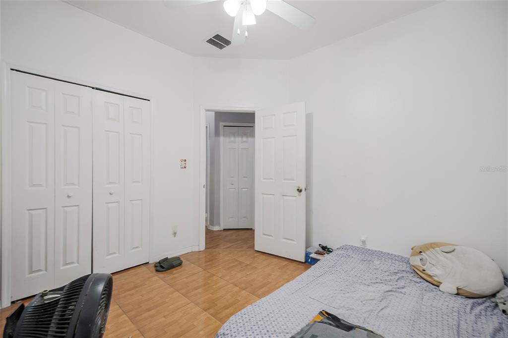 2782 Andes Way St. Cloud, FL 34769 - Photo 41 of 42 a bedroom with a bed and a chandelier