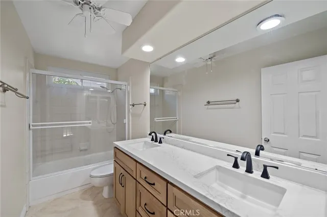 a bathroom with a sink double vanity granite tub and shower