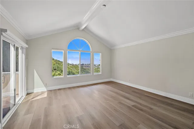 a view of room with window and wooden floor