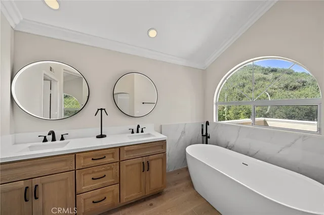 a bathroom with a double vanity sink and a mirror