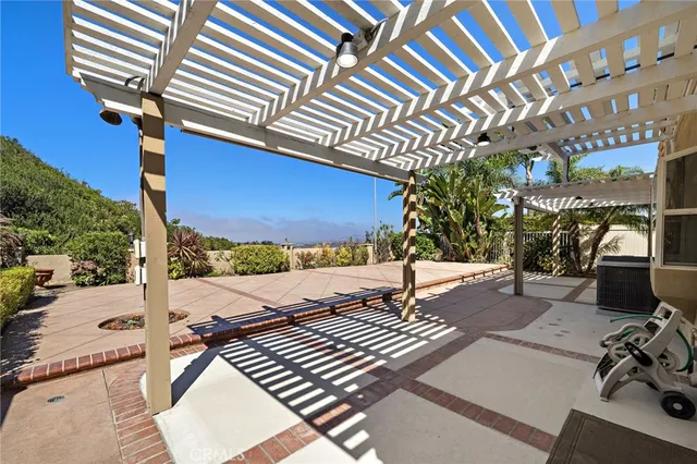 a view of a patio with table and chairs with wooden floor and fence