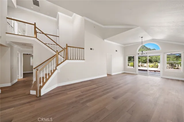 a view of an entryway with wooden floor
