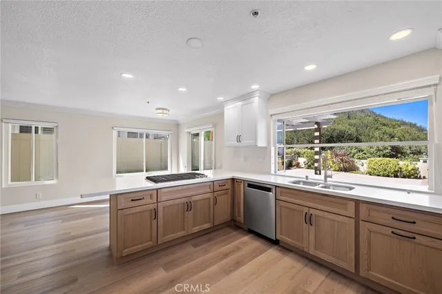 a large white kitchen with a large window