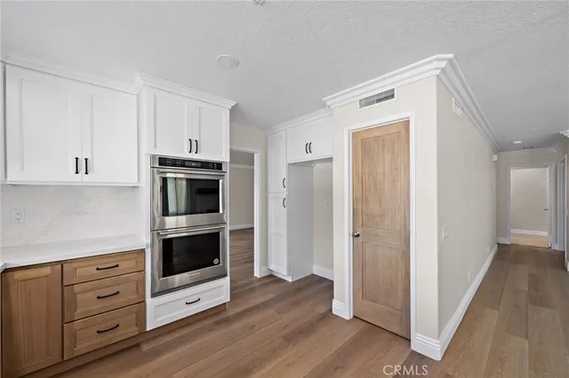a kitchen with stainless steel appliances and white cabinets