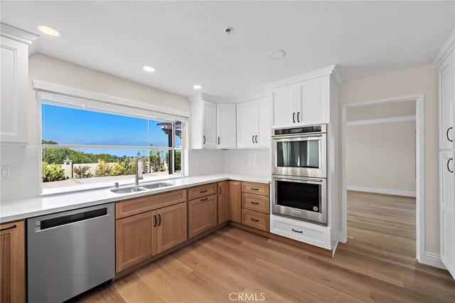 a kitchen with stainless steel appliances granite countertop a stove and a sink