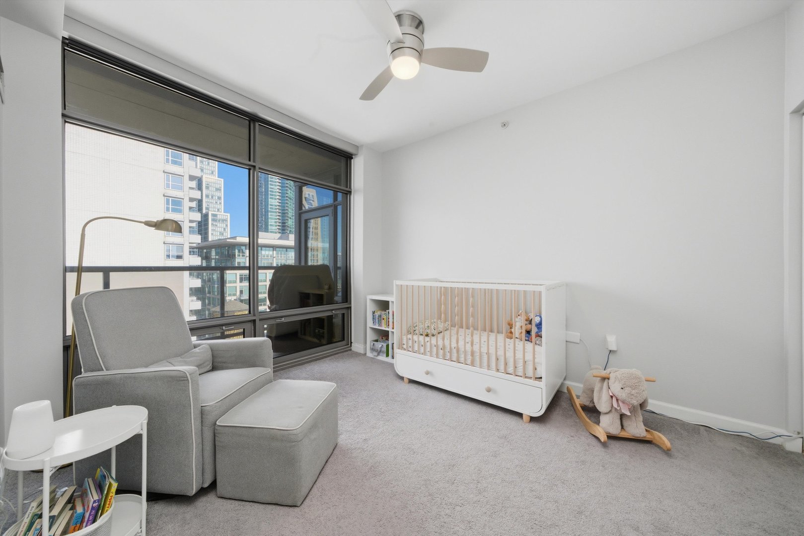 100 East 14th Street, Unit 1401 Chicago, IL 60605 - Photo 14 of 28 a living room with furniture a flat screen tv and a window