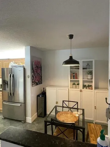 a living room with furniture a chandelier and a window
