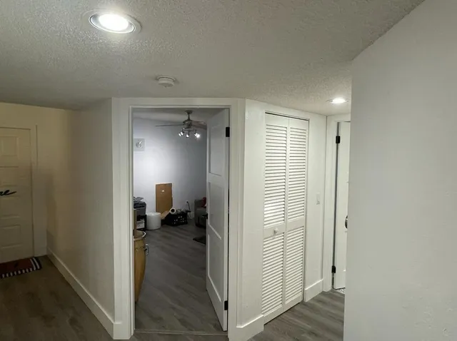 a view of a hallway with a livingroom and a chair