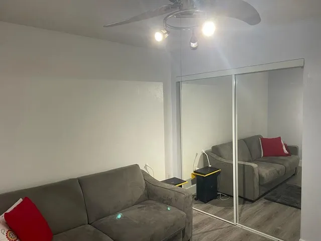 a living room with furniture and a lamp