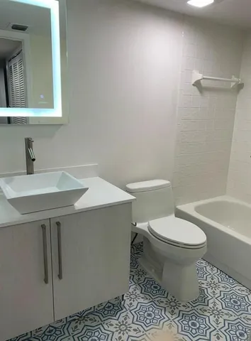 a bathroom with a sink toilet and a bathtub