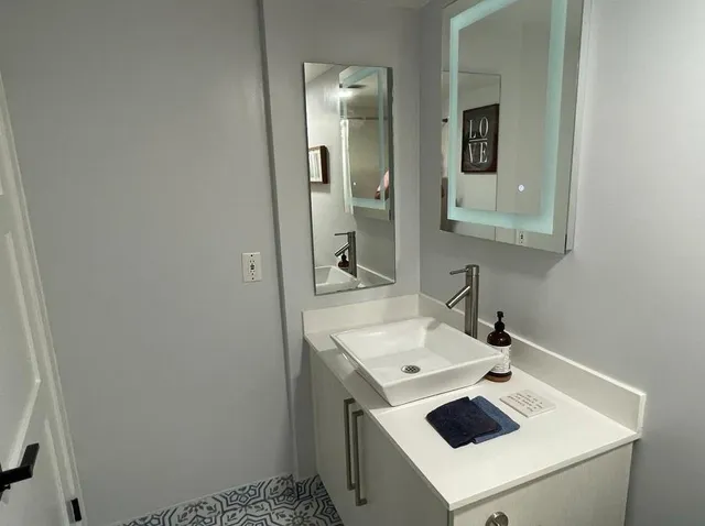 a bathroom with a sink and a mirror