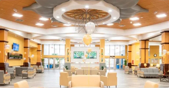 a backyard of a house with barbeque oven table and chairs