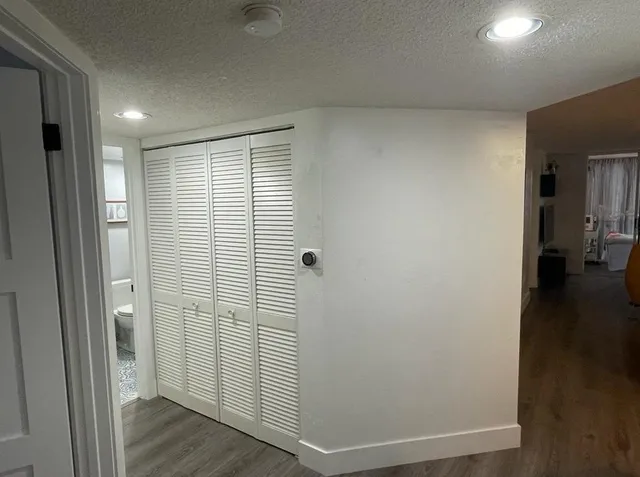 a view of a room with wooden floor