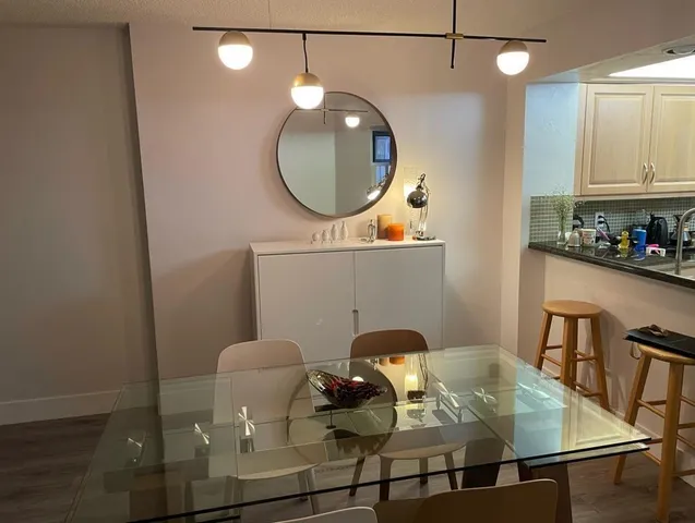 a kitchen with a table chairs and a stove